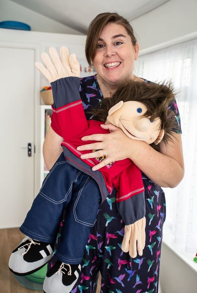 Amy and Mascot waving in therapy room
